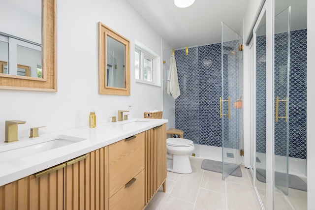 bathroom featuring vanity, toilet, tile patterned floors, and walk in shower