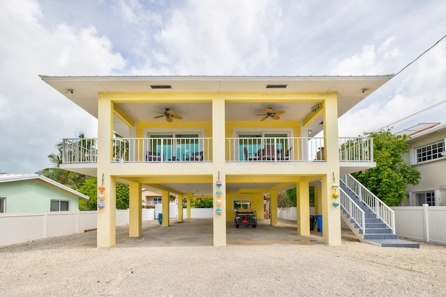 view of front of home with ceiling fan, a carport, and covered porch