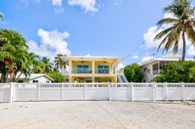 view of front of property with a balcony and ceiling fan