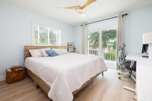 bedroom featuring access to exterior, light hardwood / wood-style floors, a textured ceiling, and ceiling fan