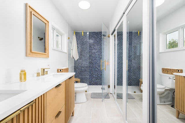 bathroom featuring tile patterned floors, toilet, and an enclosed shower