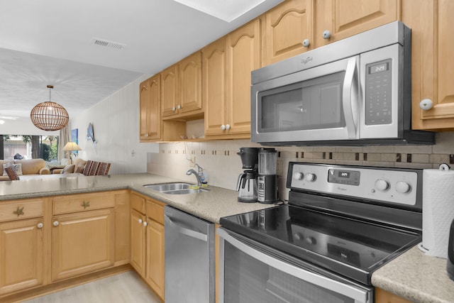 87200 Overseas Hwy Unit O9, Islamorada, FL 33036 - kitchen featuring stainless steel appliances, light countertops, backsplash, and decorative light fixtures