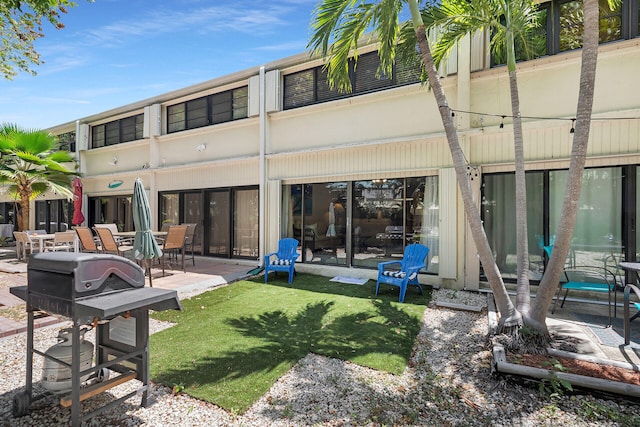 87200 Overseas Hwy Unit O9, Islamorada, FL 33036 - back of property featuring a patio and a lawn