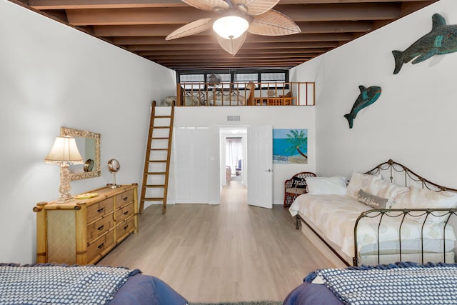 87200 Overseas Hwy Unit O9, Islamorada, FL 33036 - bedroom with beam ceiling, wood finished floors, and a ceiling fan