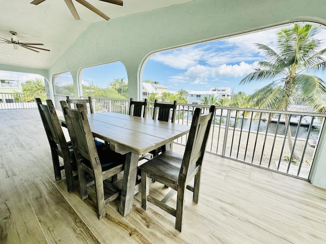 wooden terrace featuring a water view and ceiling fan