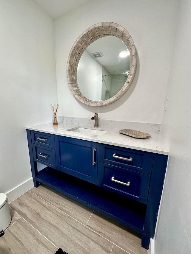 bathroom featuring vanity, wood-type flooring, and toilet