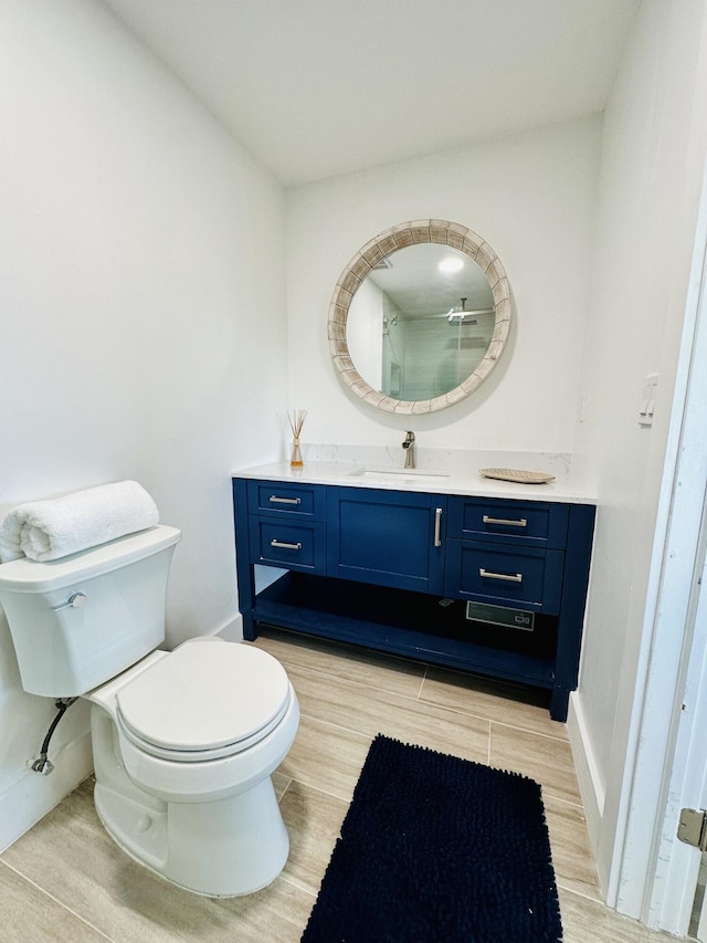 bathroom featuring vanity, hardwood / wood-style floors, and toilet