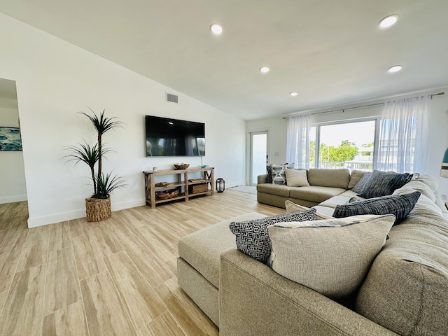 living room with lofted ceiling and light wood-type flooring