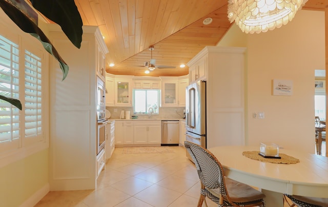 1323 Hudgins Dr, Summerland, FL 33042 - kitchen featuring a sink, light tile patterned flooring, wood ceiling, glass insert cabinets, and appliances with stainless steel finishes
