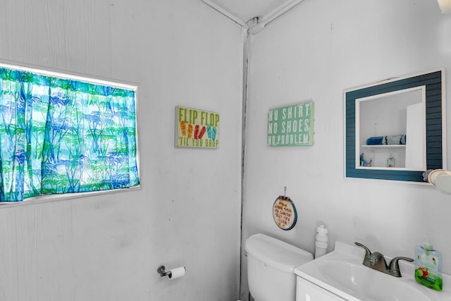 half bathroom featuring toilet and vanity