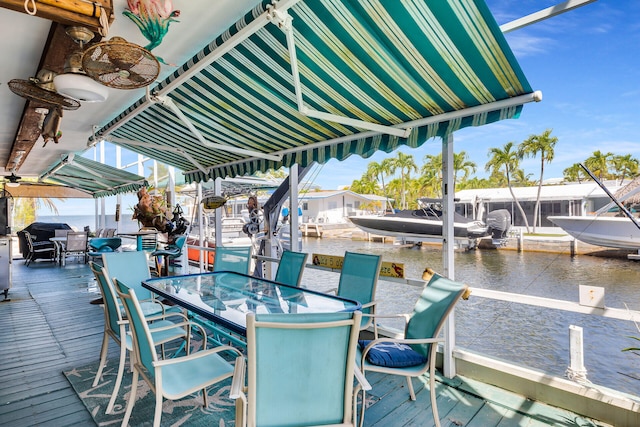 dock area featuring outdoor dining area and a water view