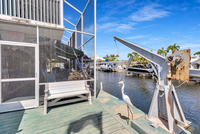 dock area featuring boat lift and a water view