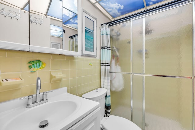 full bath featuring a stall shower, tasteful backsplash, toilet, and tile walls