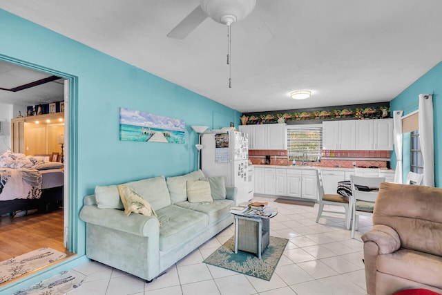 living room with ceiling fan and light tile patterned flooring