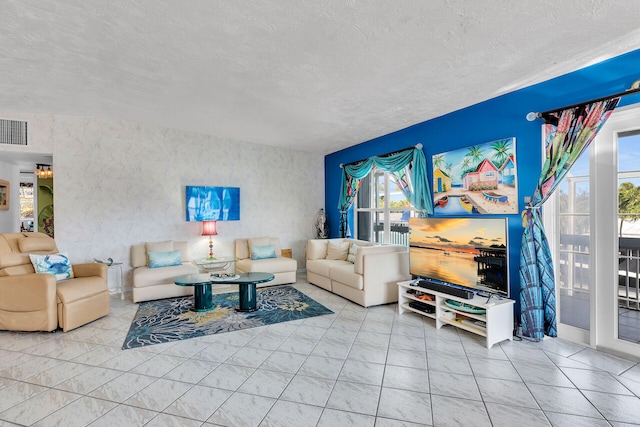 living room featuring a textured ceiling and visible vents