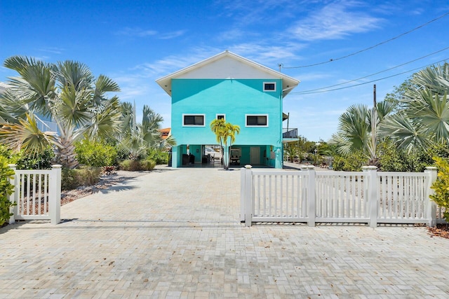 26 Corrine Pl, Key Largo, FL 33037 - coastal home with a carport, a fenced front yard, driveway, and a balcony