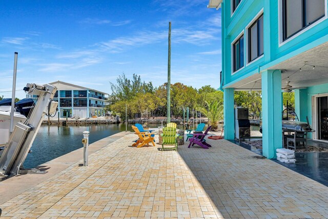 26 Corrine Pl, Key Largo, FL 33037 - view of patio with a boat dock and a water view