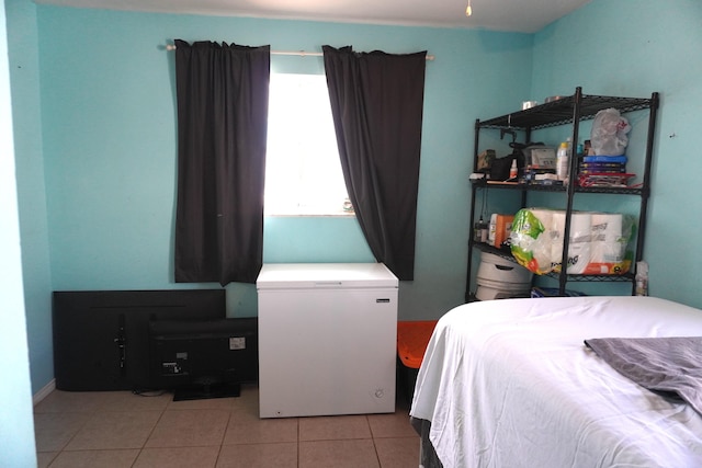 tiled bedroom featuring fridge