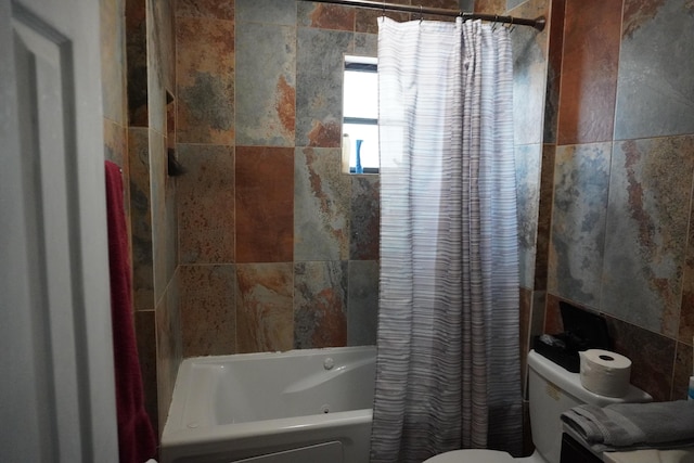 bathroom with toilet, shower / bathtub combination with curtain, and tile walls