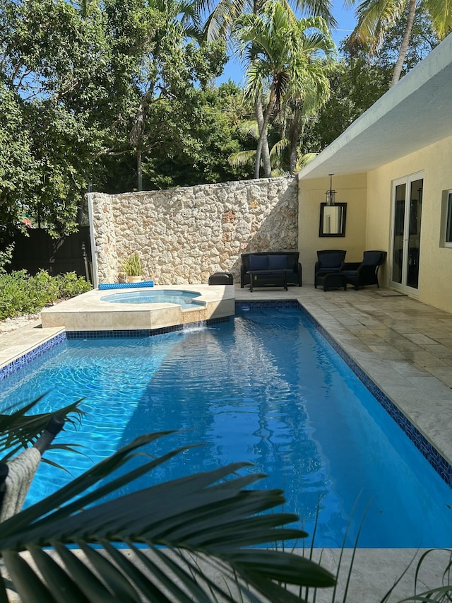 view of swimming pool featuring an in ground hot tub and a patio area