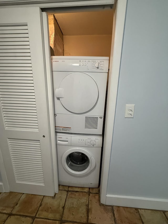 washroom with stacked washing maching and dryer