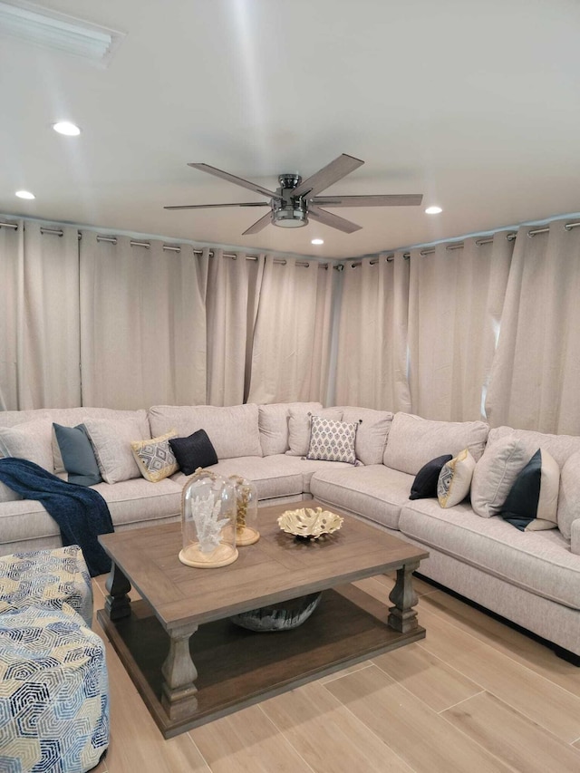 living room with light hardwood / wood-style floors and ceiling fan