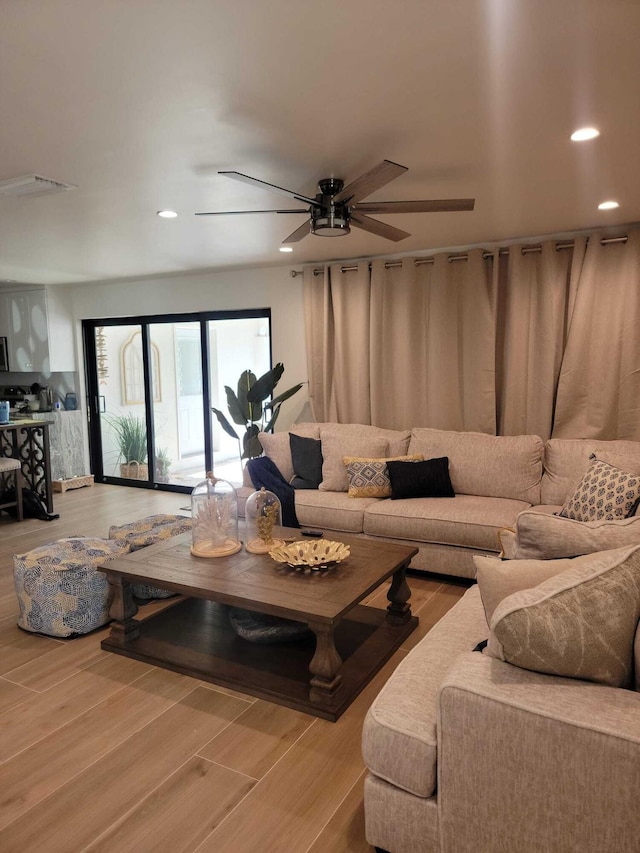 living room with hardwood / wood-style floors and ceiling fan