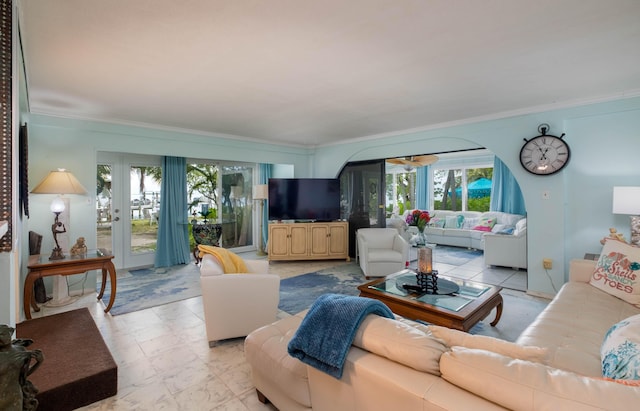 living area featuring plenty of natural light and crown molding