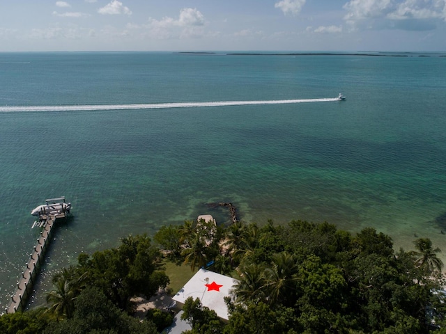 aerial view of property and surrounding area with a nearby body of water