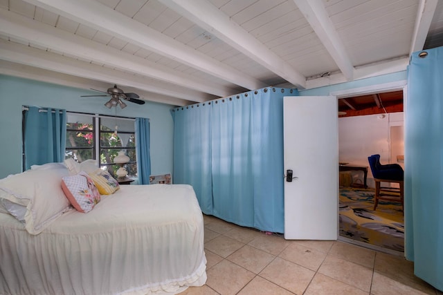 bedroom featuring beamed ceiling, light tile patterned floors, and wooden ceiling