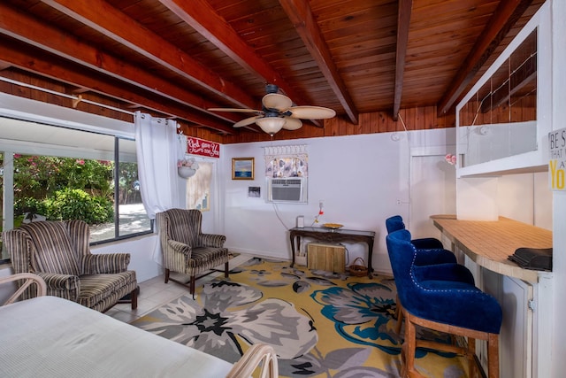 living room featuring beam ceiling, a ceiling fan, wood ceiling, light tile patterned floors, and wooden walls