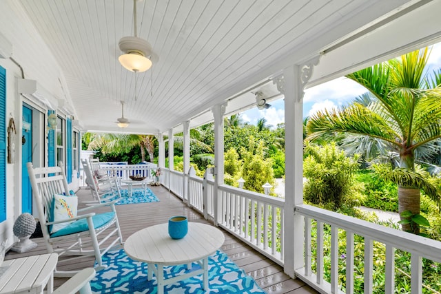 wooden terrace featuring ceiling fan