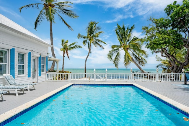 view of pool with a water view and a patio area