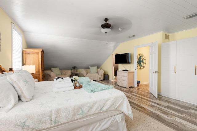 bedroom featuring ceiling fan, lofted ceiling, and light hardwood / wood-style floors