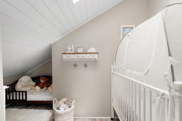 bedroom featuring wood ceiling and vaulted ceiling