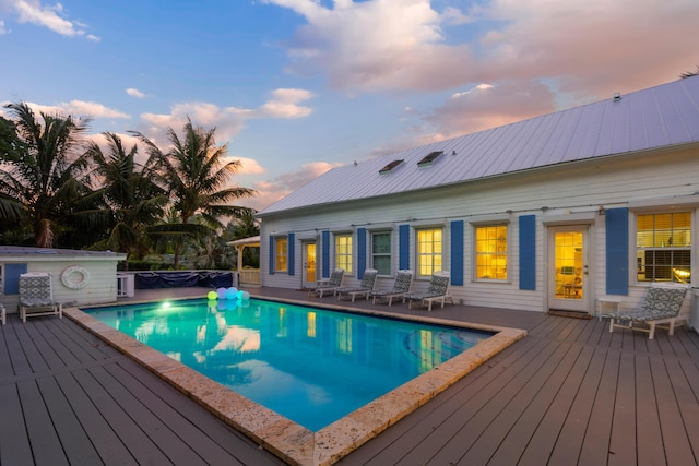 pool at dusk with a deck