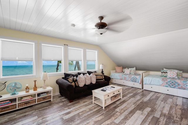 bedroom featuring a water view, ceiling fan, vaulted ceiling, and hardwood / wood-style floors