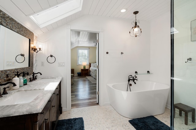 bathroom featuring a washtub, wood ceiling, tile patterned flooring, vanity, and vaulted ceiling