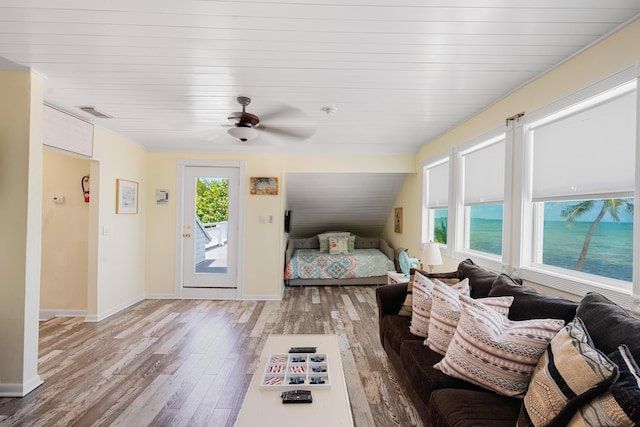 bedroom with ceiling fan, wood-type flooring, and access to outside