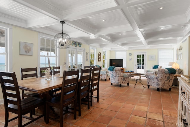 dining room with coffered ceiling, a notable chandelier, beam ceiling, and french doors