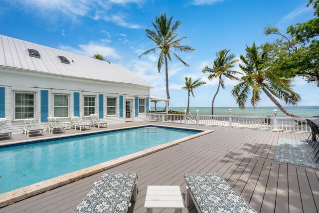 view of swimming pool with a deck with water view