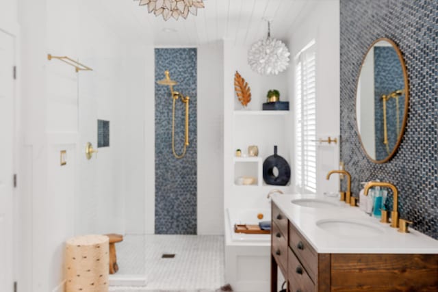 bathroom with vanity and shower with separate bathtub