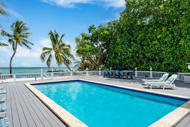 view of swimming pool featuring a water view