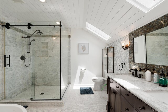 bathroom with tile patterned flooring, vaulted ceiling with skylight, an enclosed shower, vanity, and tasteful backsplash