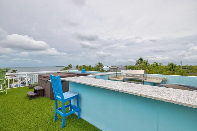 view of pool featuring a water view, a grill, and a yard