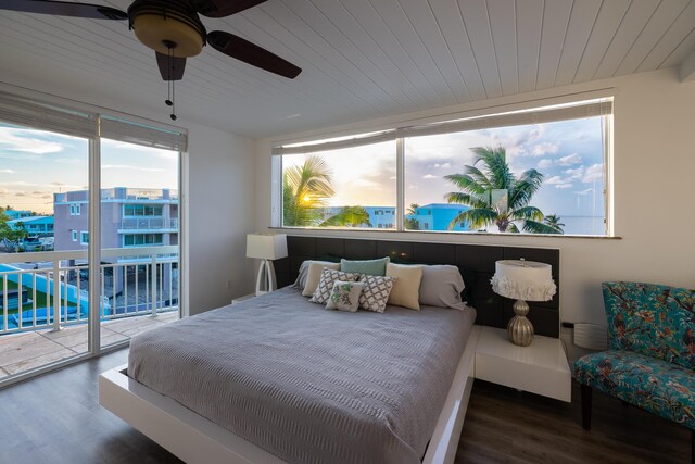 bedroom with dark wood-type flooring, ceiling fan, access to exterior, and wooden ceiling