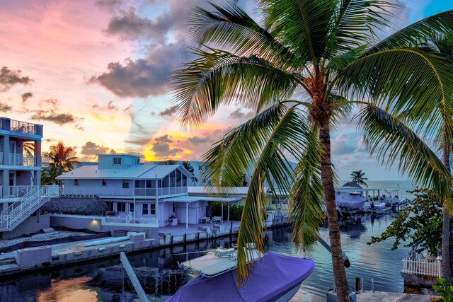 view of dock with a patio area and a water view