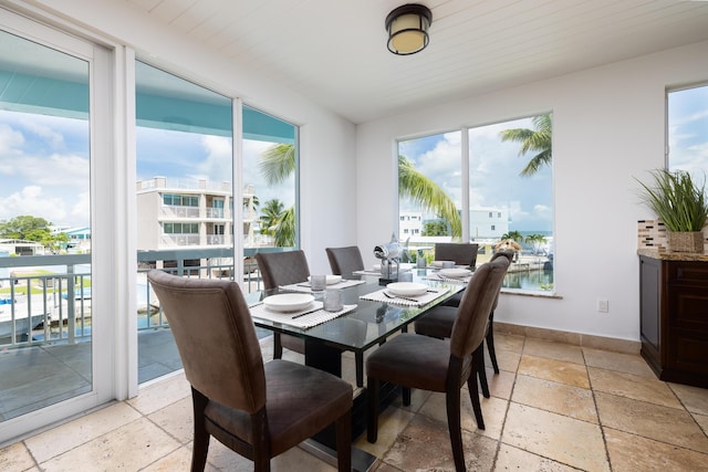 dining room with plenty of natural light and a water view