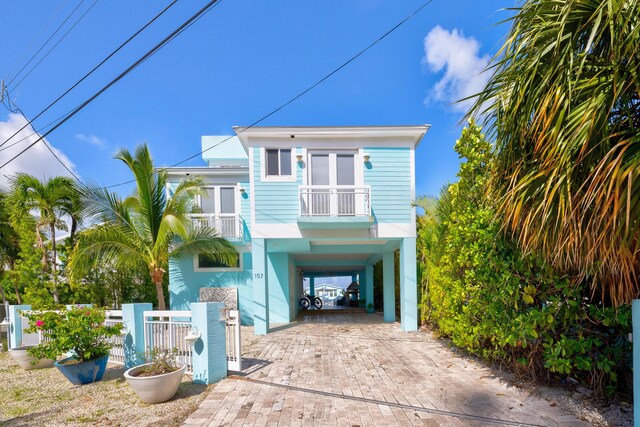 coastal home with a carport and a balcony