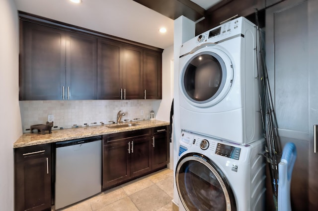 laundry room with sink and stacked washer / dryer